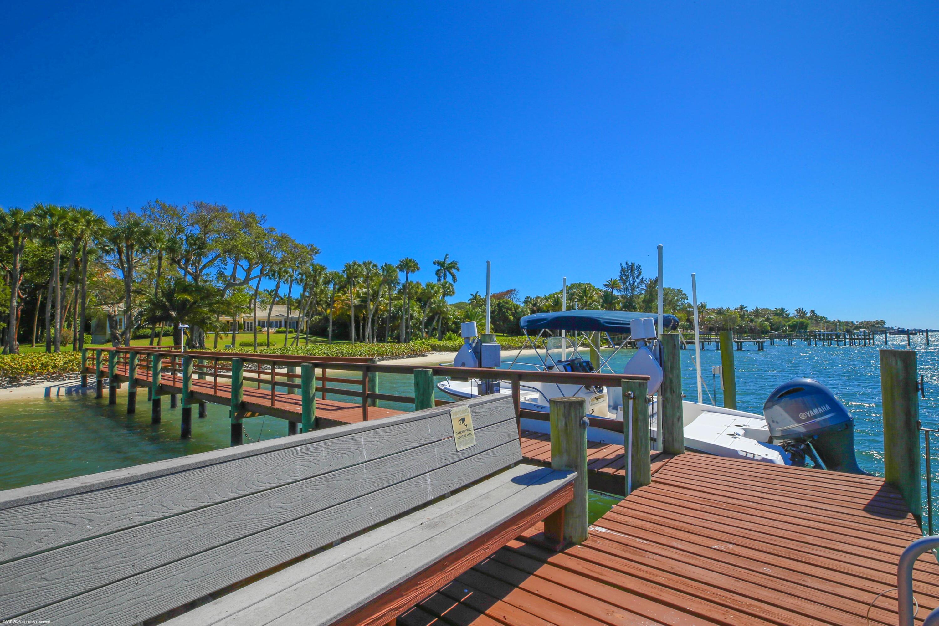 228 South Beach Road Jupiter Island, FL 33455 - Photo 37 of 40 a view of a balcony with two chairs and a table