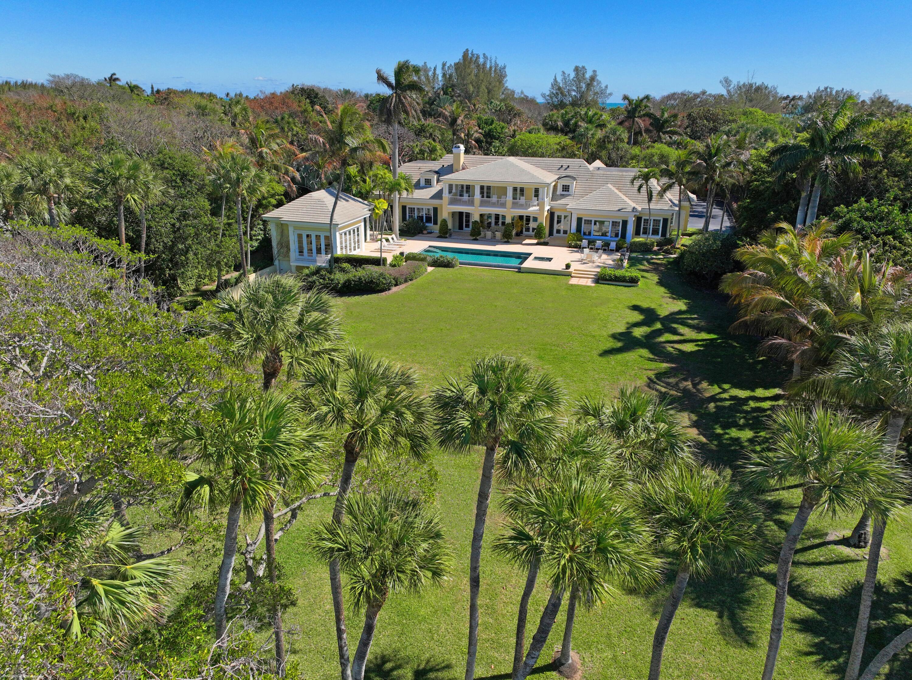 228 South Beach Road Jupiter Island, FL 33455 - Photo 39 of 40 an aerial view of a house with swimming pool and mountain view