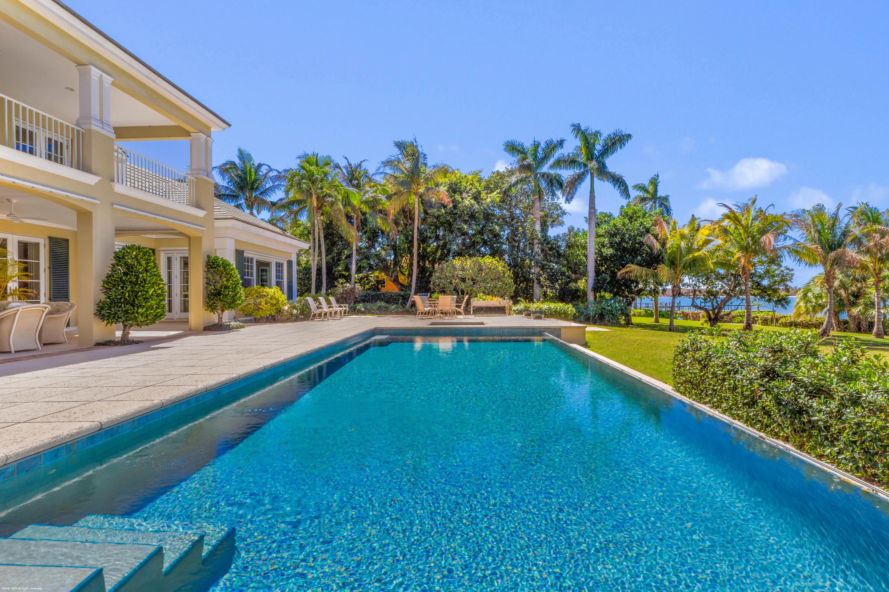 228 South Beach Road Jupiter Island, FL 33455 - Photo 5 of 40 a view of swimming pool with outdoor seating and a yard