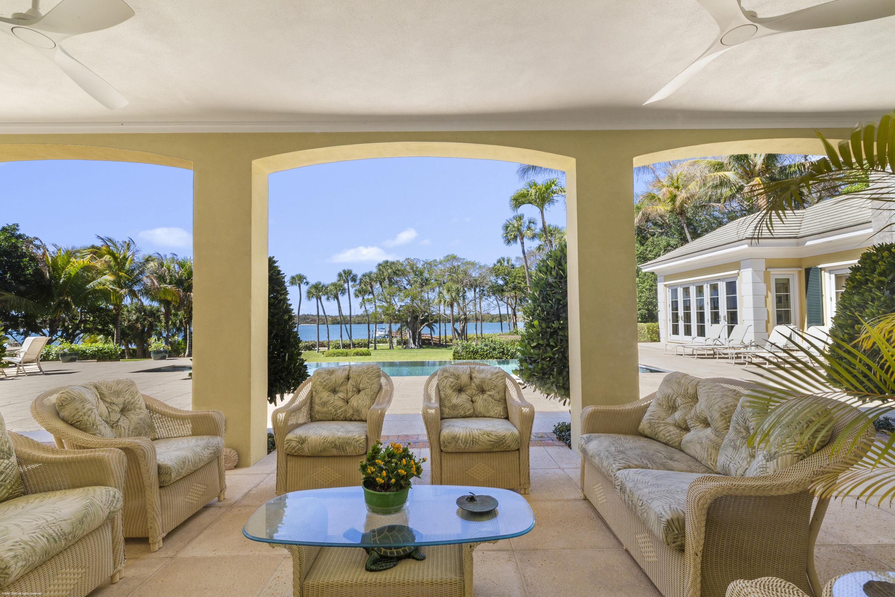 228 South Beach Road Jupiter Island, FL 33455 - Photo 7 of 40 a living room with furniture and a large window