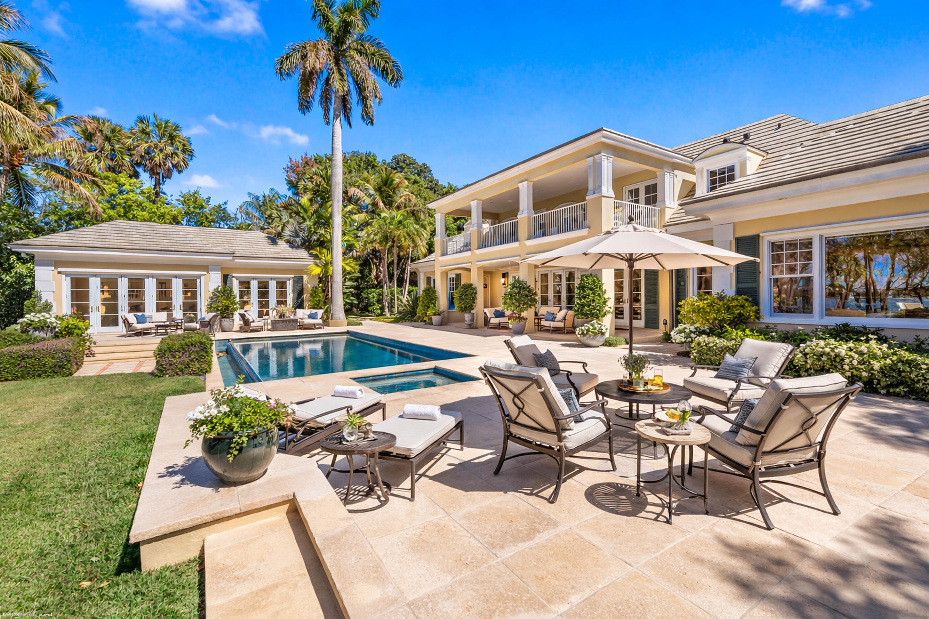 228 South Beach Road Jupiter Island, FL 33455 - Photo 8 of 40 a view of a patio with couches table and chairs and potted plants