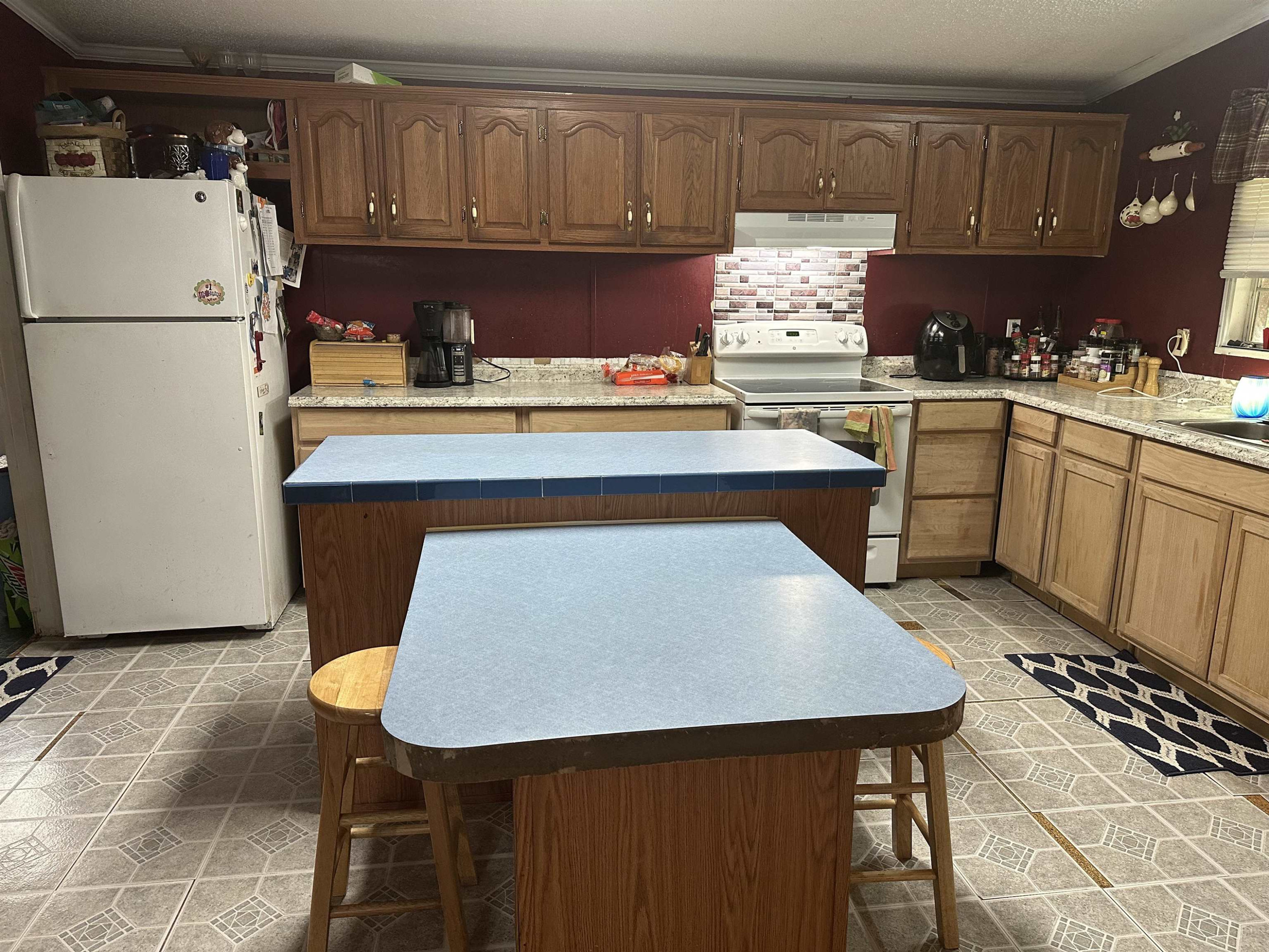 440 Lester Burch Road Roxboro, NC 27574 - Photo 5 of 7 a kitchen with a table chairs sink and cabinets