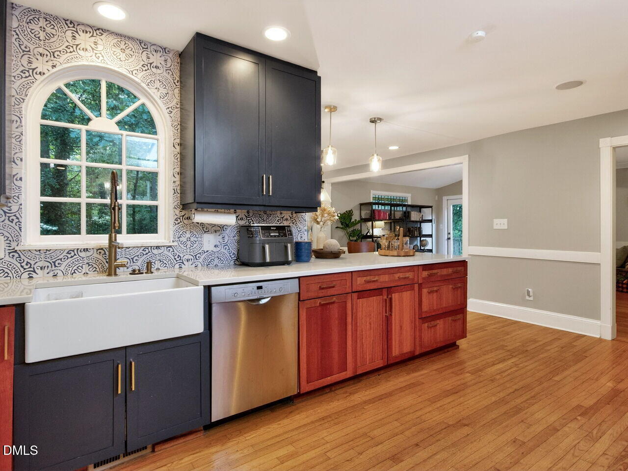 6004 Tarnhour Court Raleigh, NC 27612 - Photo 12 of 44 a kitchen with stainless steel appliances granite countertop wooden cabinets a sink and a large window