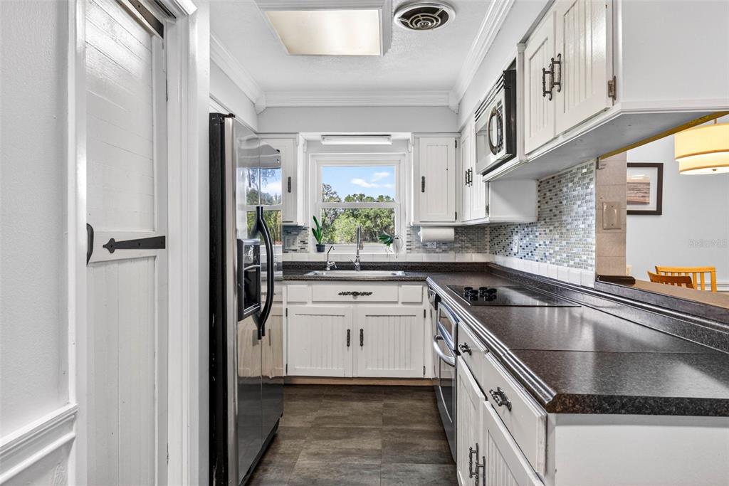 16330 Hanna Road Lutz, FL 33549 - Photo 13 of 41 a kitchen with stainless steel appliances granite countertop a sink and a refrigerator