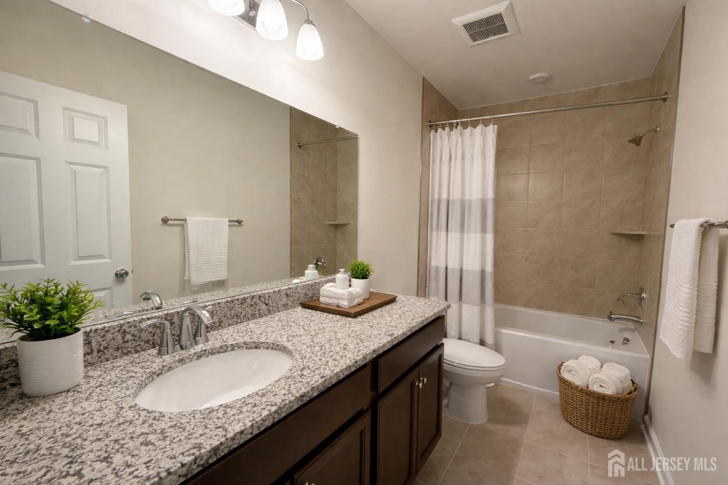 616 Sadie Circle New Brunswick, NJ 08901 - Photo 11 of 18 a bathroom with a granite countertop sink and a mirror