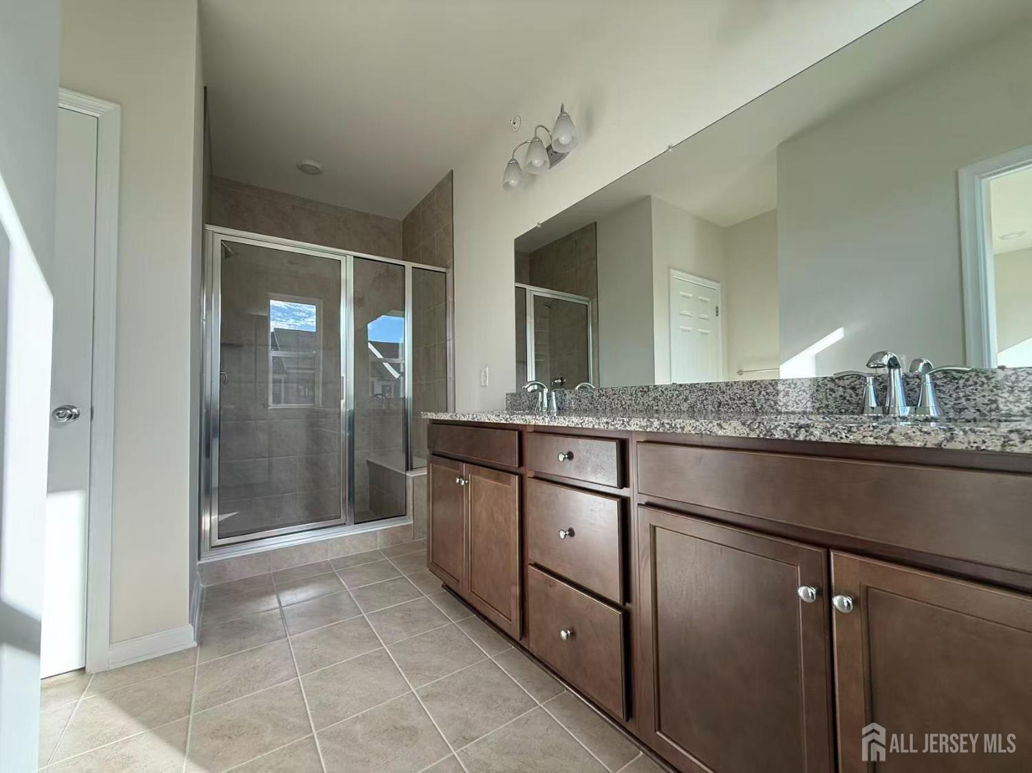 616 Sadie Circle New Brunswick, NJ 08901 - Photo 6 of 18 a bathroom with a granite countertop sink and a mirror