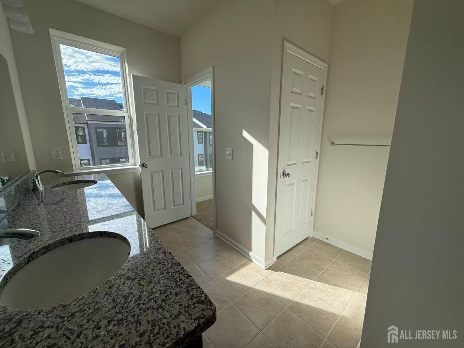 616 Sadie Circle New Brunswick, NJ 08901 - Photo 7 of 18 a bathroom with a granite countertop sink a mirror and shower