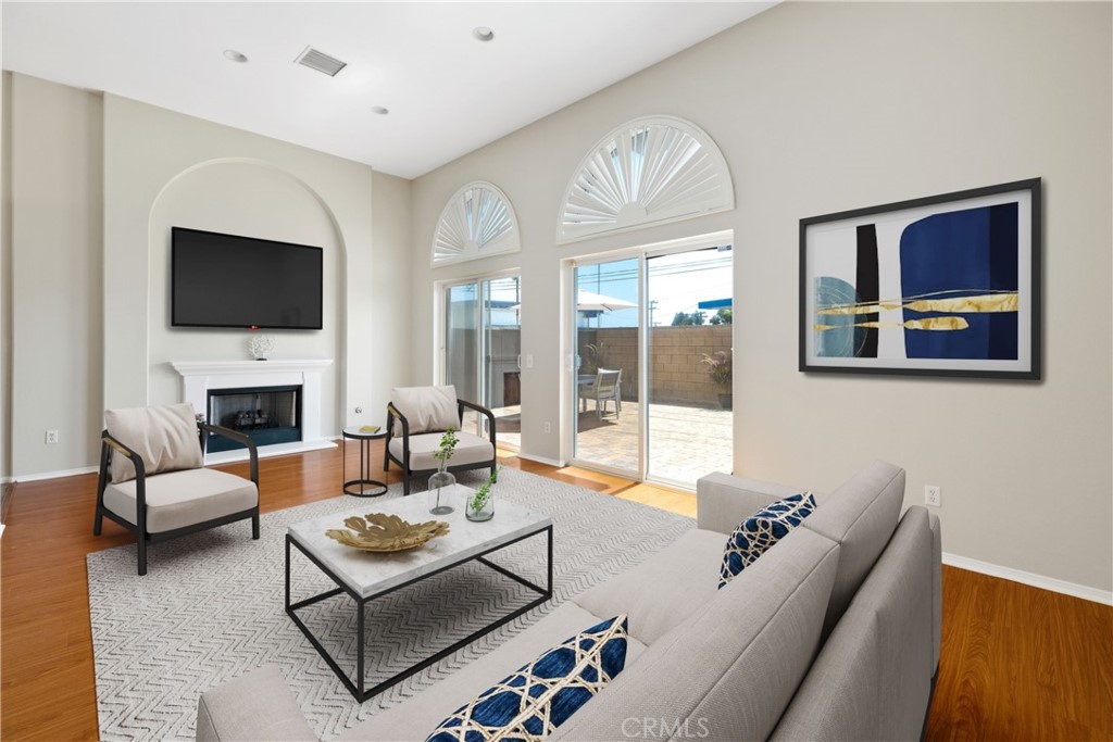 a living room with furniture a fireplace and a flat screen tv