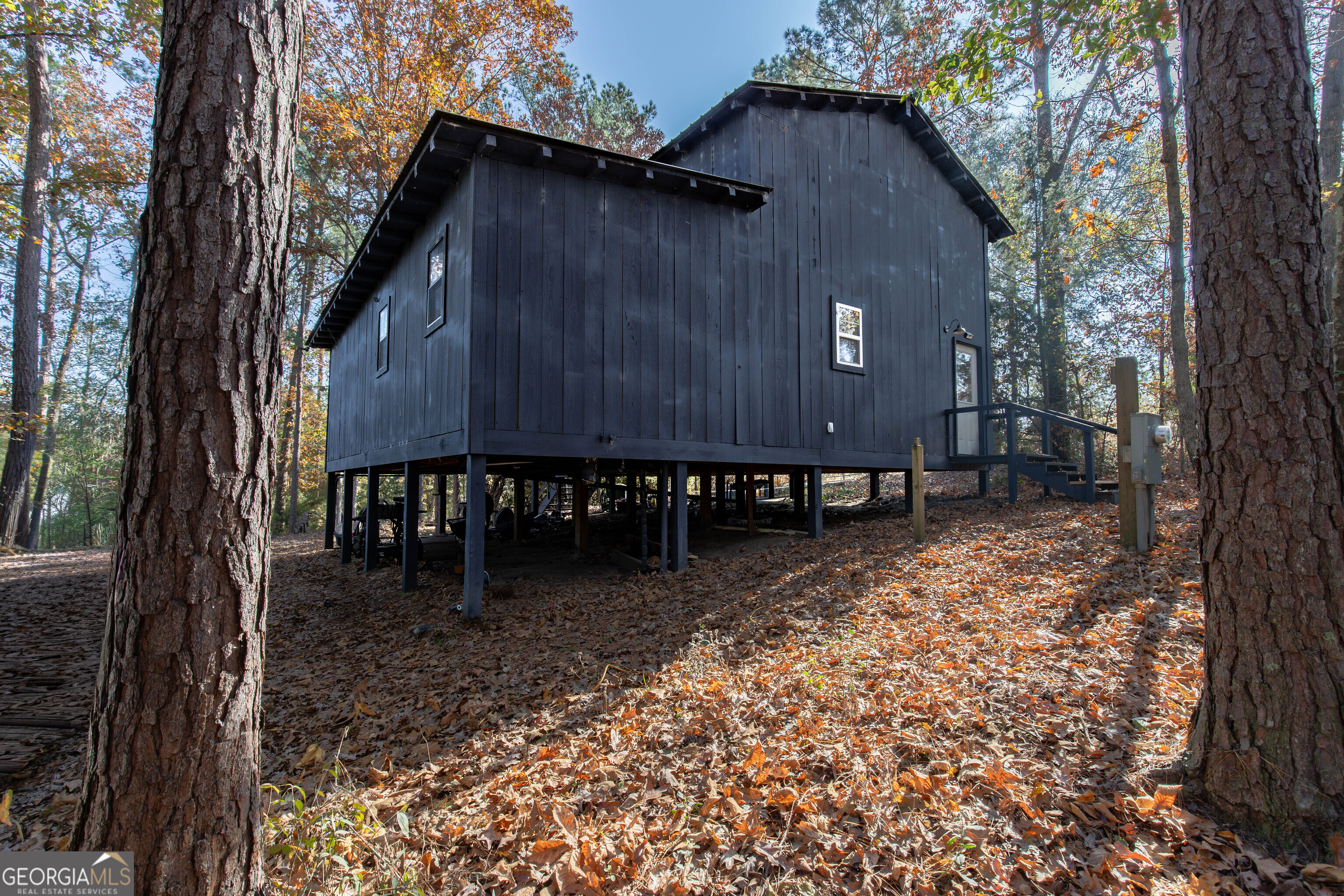 2286 Carter Bight Landing Road Surrency, GA 31563 - Photo 34 of 35 a view of a backyard with a large tree and wooden fence