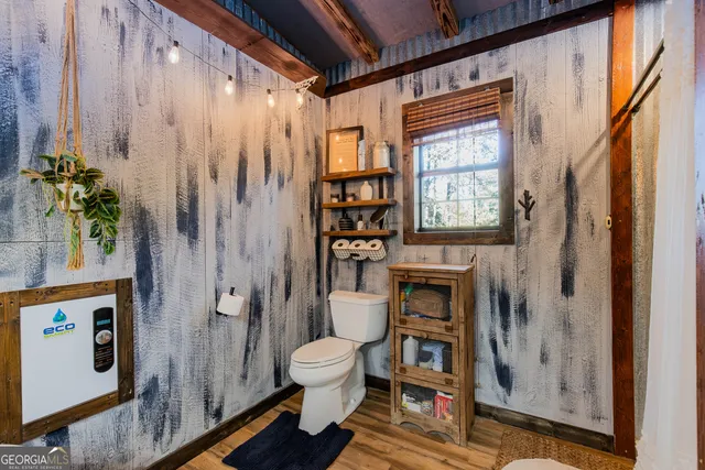 a bathroom with a toilet and a shower