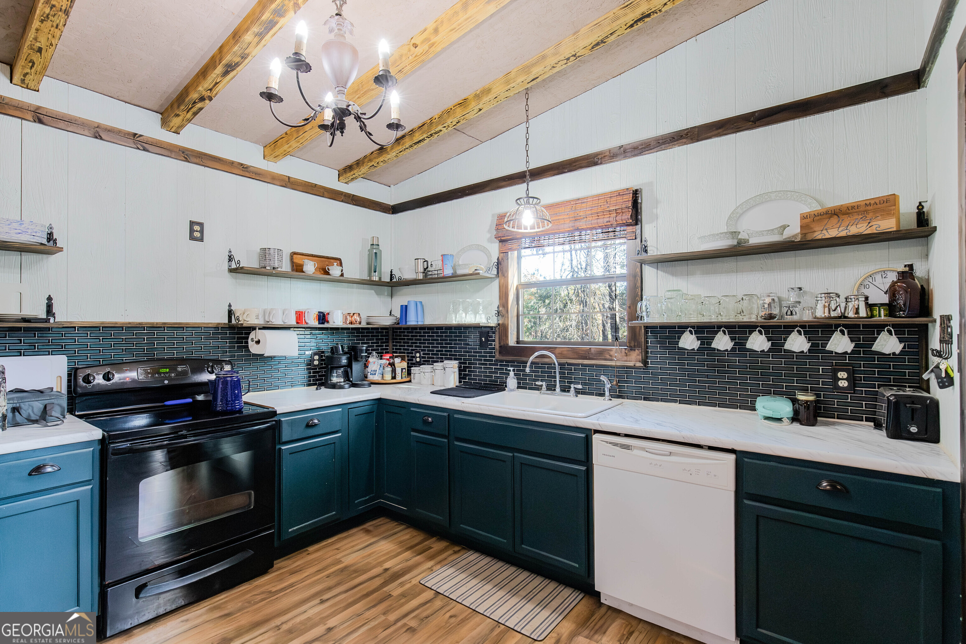 2286 Carter Bight Landing Road Surrency, GA 31563 - Photo 6 of 35 a kitchen with stainless steel appliances granite countertop a sink a stove and cabinets
