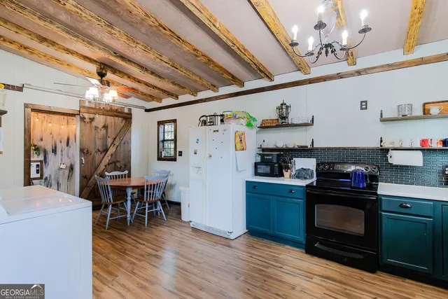 a kitchen with stainless steel appliances granite countertop a refrigerator and a stove top oven