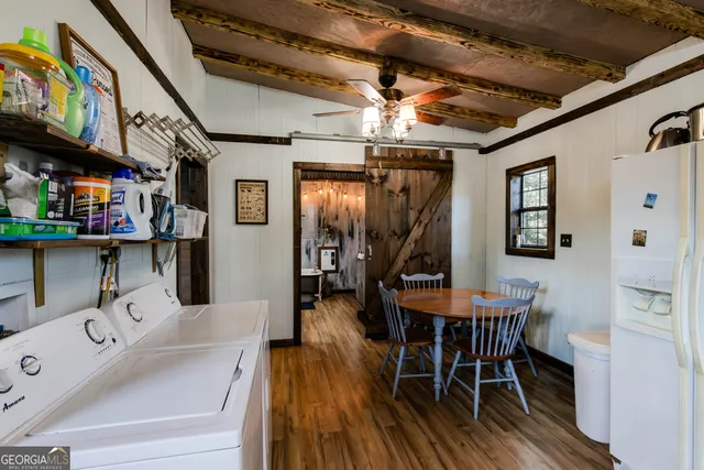 a dining room with furniture and wooden floor