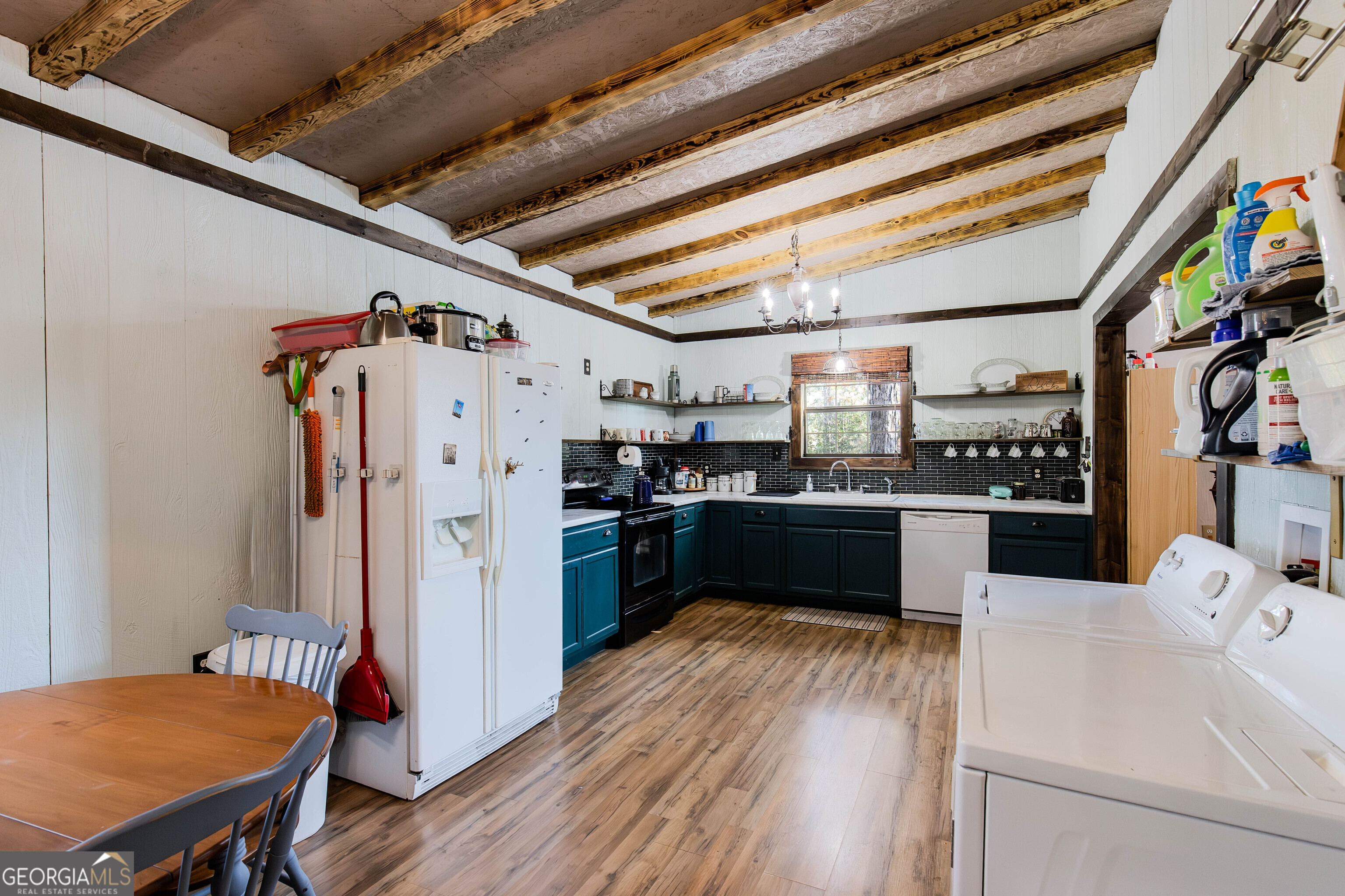 2286 Carter Bight Landing Road Surrency, GA 31563 - Photo 9 of 35 a kitchen with stainless steel appliances kitchen island granite countertop a refrigerator and a stove
