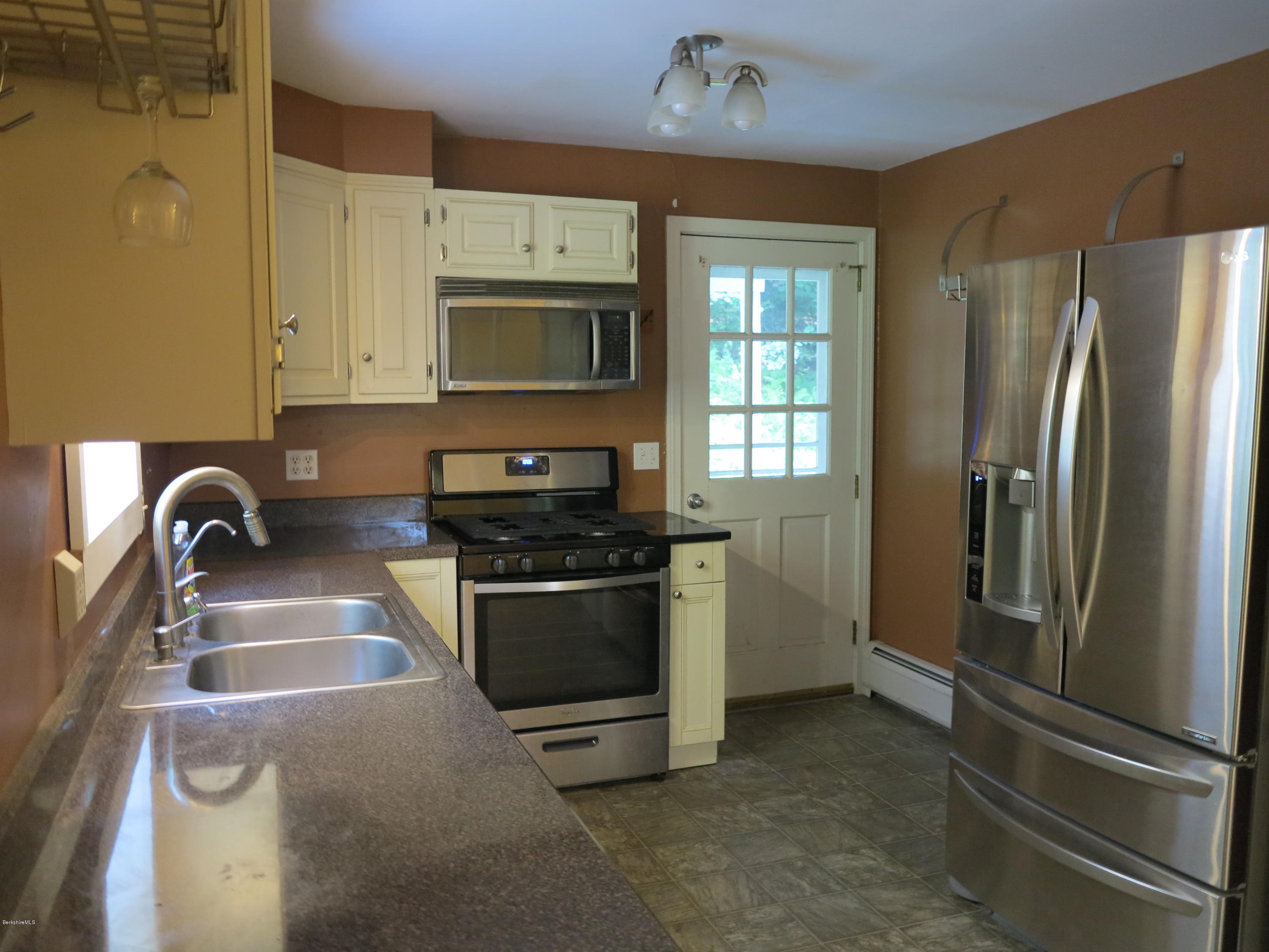 98 Tyringham Road Otis, MA 01253 - Photo 2 of 17 a kitchen with stainless steel appliances granite countertop a refrigerator sink and stove