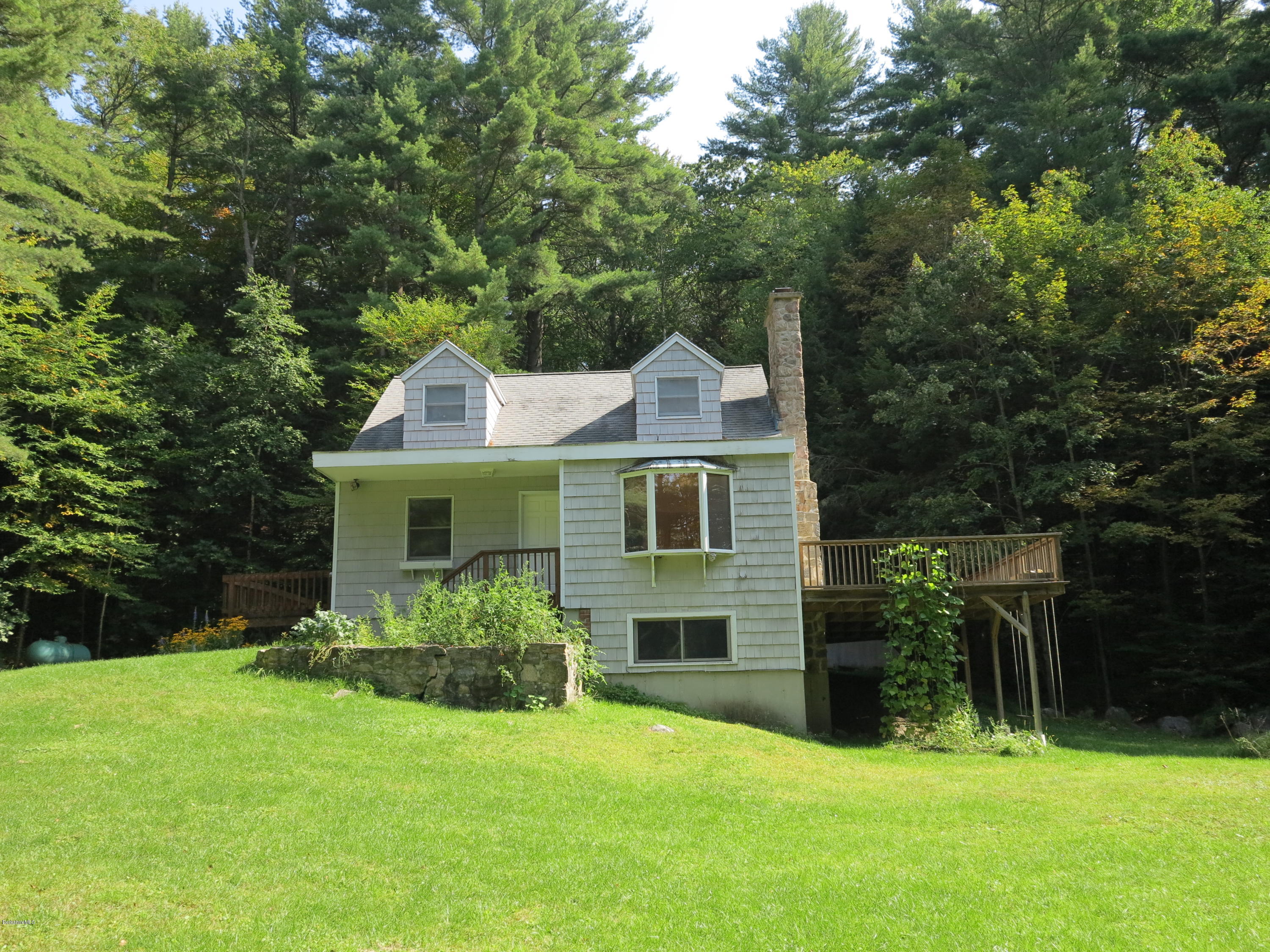 98 Tyringham Road Otis, MA 01253 - Photo 12 of 17 a front view of house with yard and green space