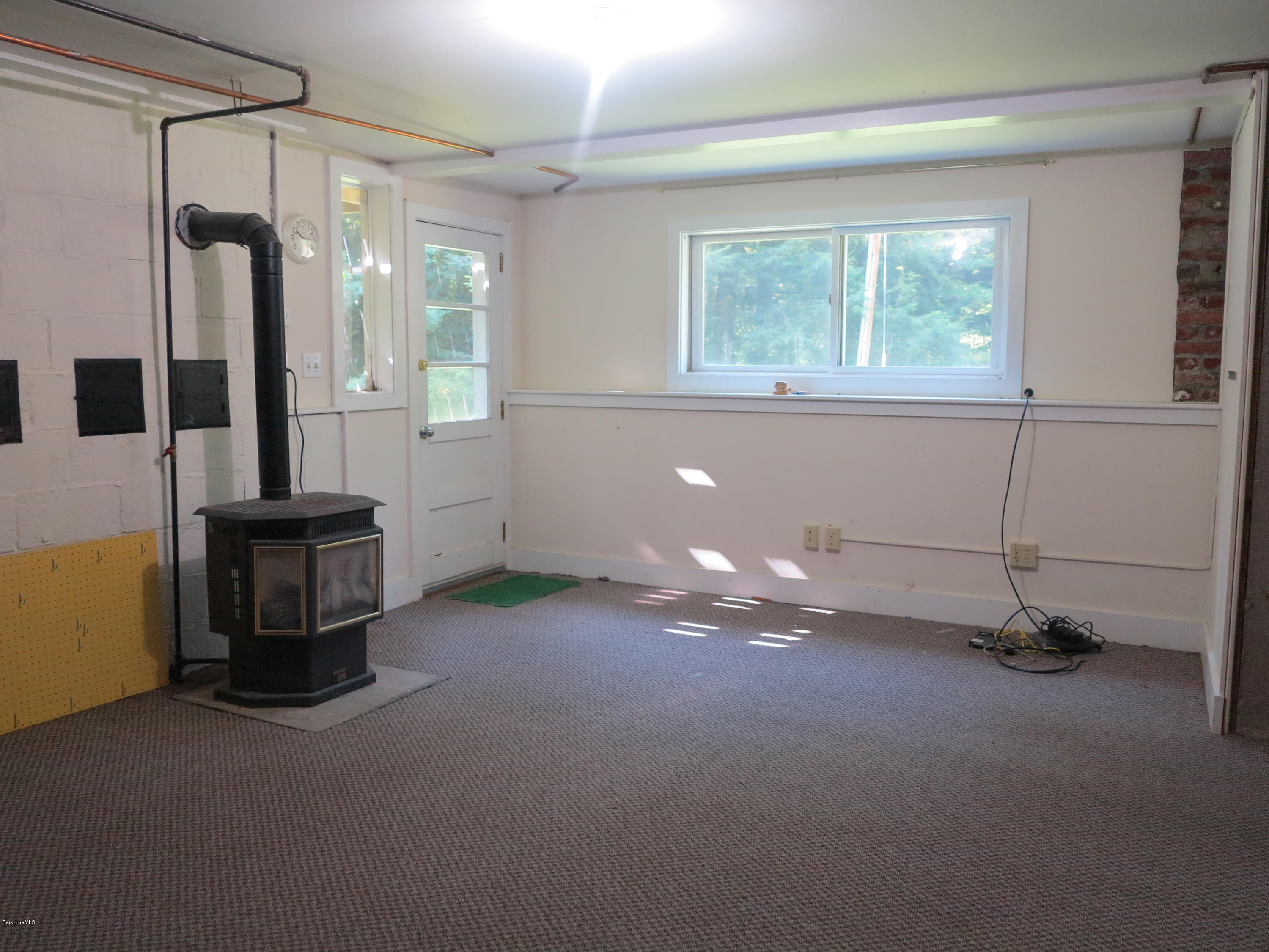 98 Tyringham Road Otis, MA 01253 - Photo 9 of 17 a view of a room with gym equipment and a window