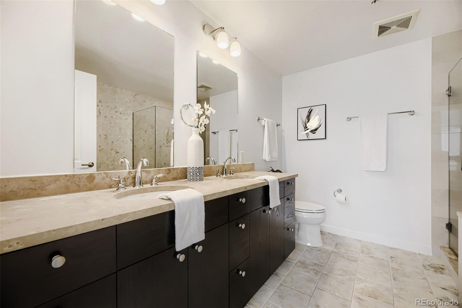 2001 Lincoln Street, Unit 710 Denver, CO 80202 - Photo 15 of 27 a view of bathroom with a sink and a mirror
