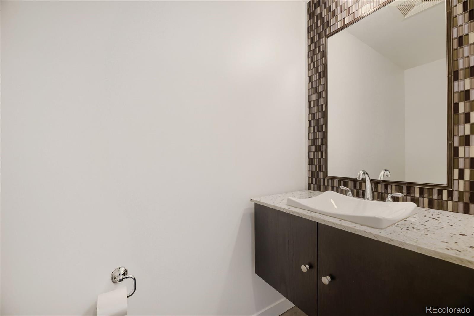 2001 Lincoln Street, Unit 710 Denver, CO 80202 - Photo 16 of 27 a bathroom with a sink and a mirror