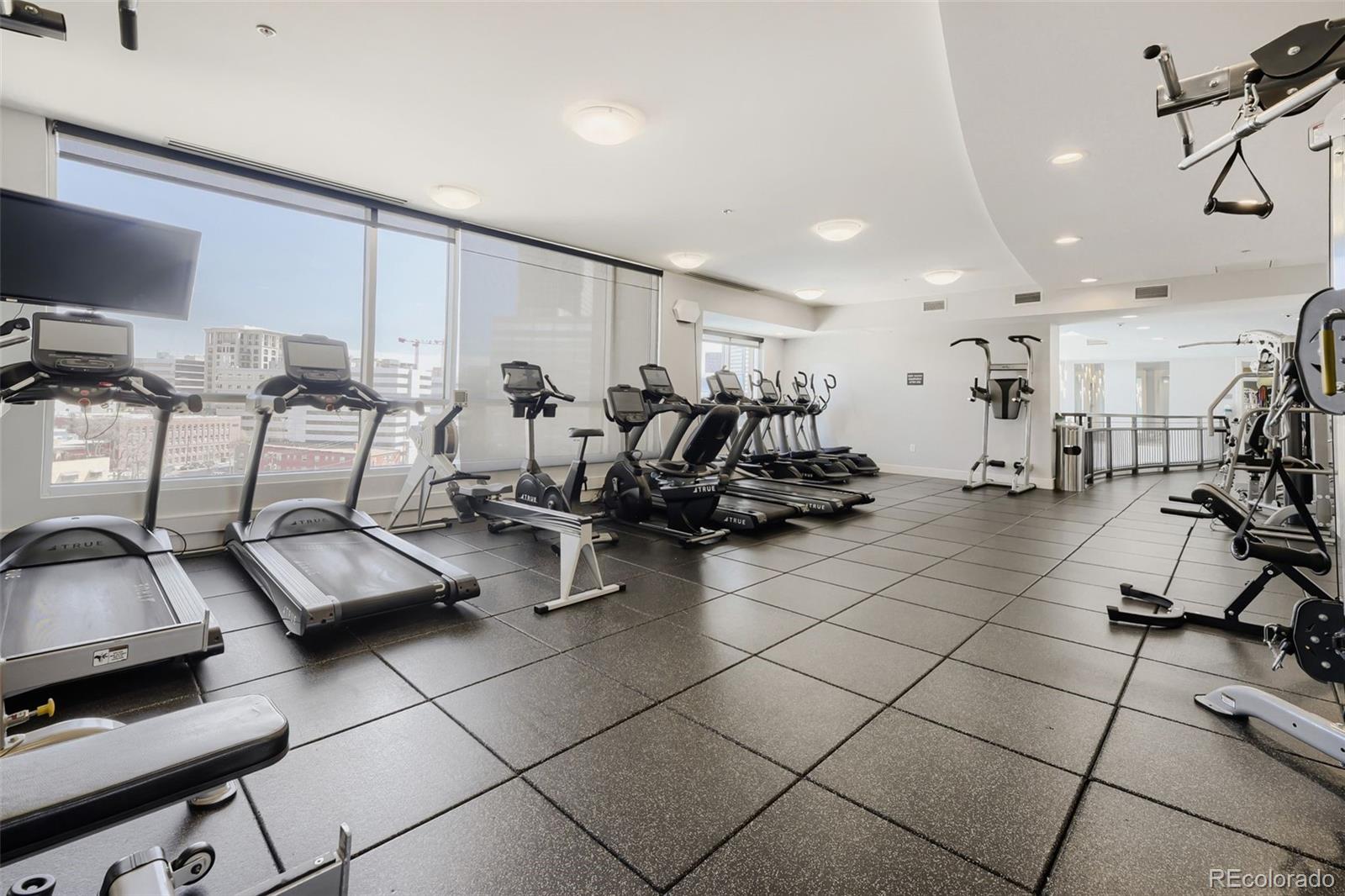 2001 Lincoln Street, Unit 710 Denver, CO 80202 - Photo 20 of 27 a room with gym equipment and a view of living room