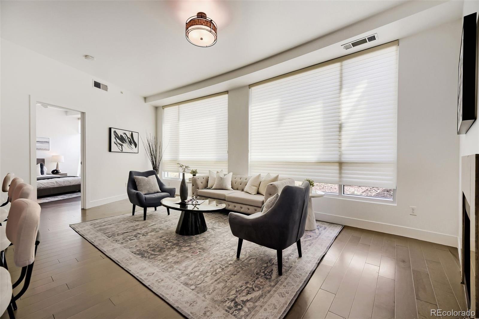 2001 Lincoln Street, Unit 710 Denver, CO 80202 - Photo 2 of 27 a living room with furniture and a window