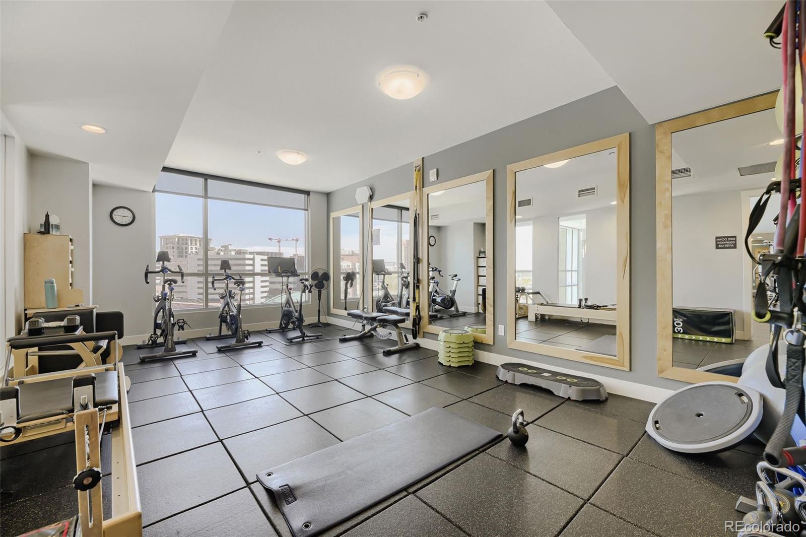 2001 Lincoln Street, Unit 710 Denver, CO 80202 - Photo 22 of 27 a room with gym equipment and view of living room