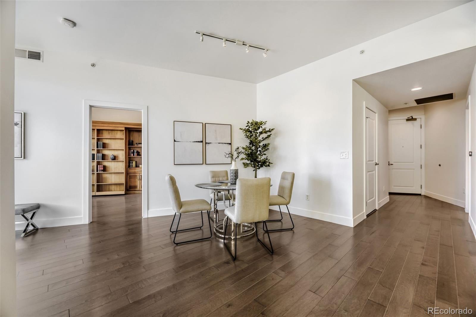 2001 Lincoln Street, Unit 710 Denver, CO 80202 - Photo 4 of 27 a view of a dining room with furniture and wooden floor