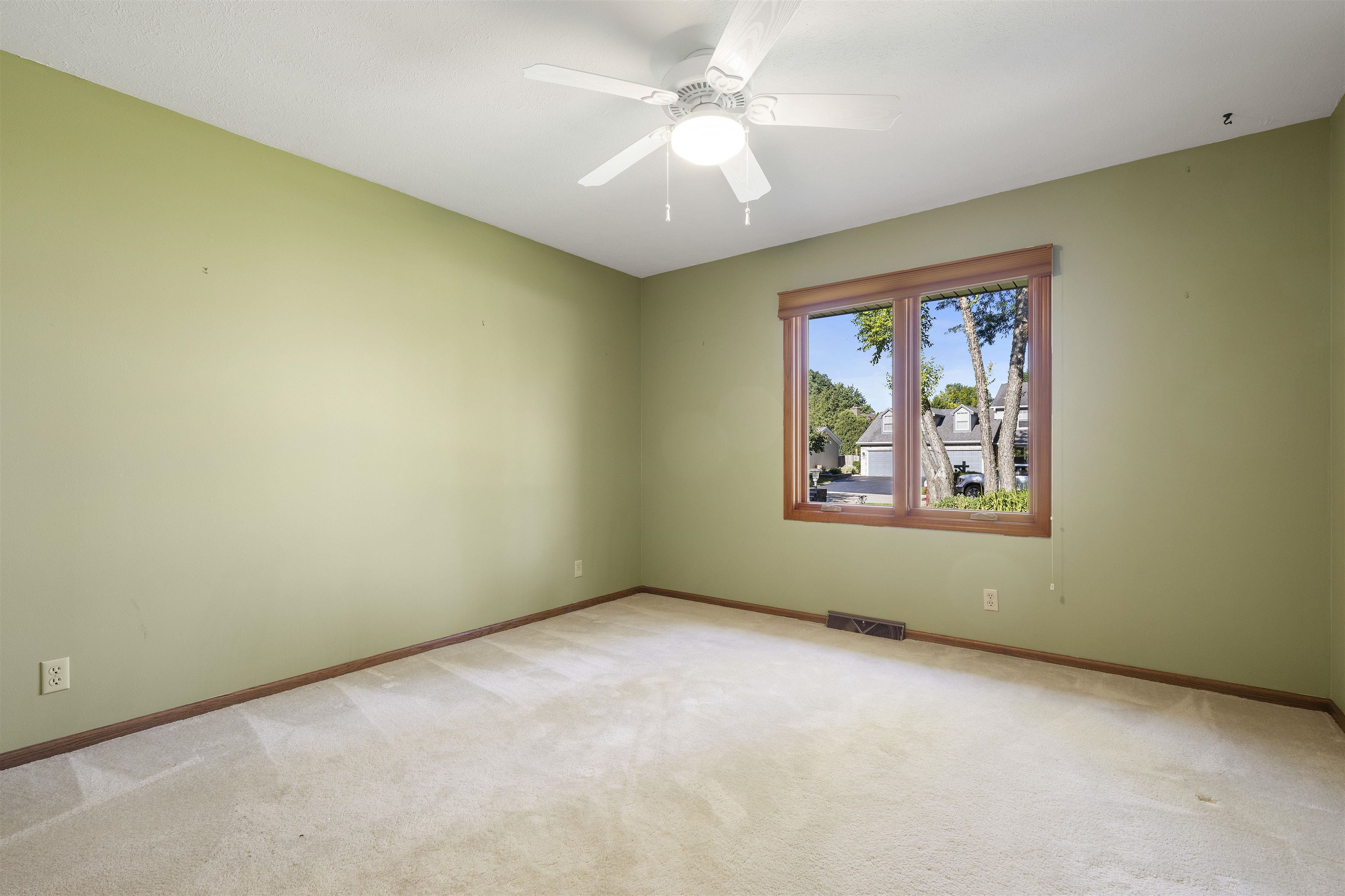1732 Rowntree Lane Rockford, IL 61107 - Photo 12 of 26 an empty room with a window and a ceiling fan