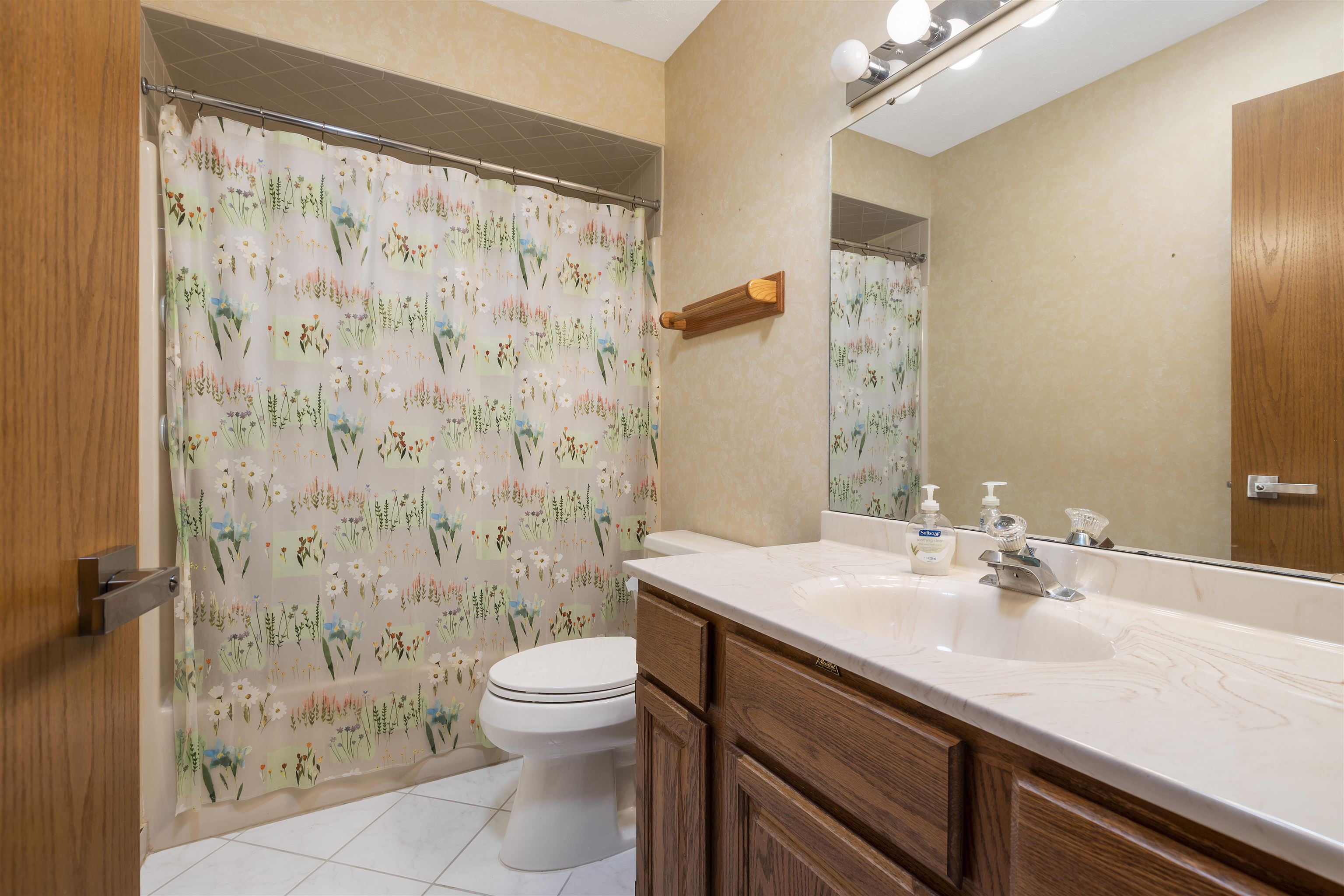 1732 Rowntree Lane Rockford, IL 61107 - Photo 14 of 26 a bathroom with a sink a toilet and shower curtain