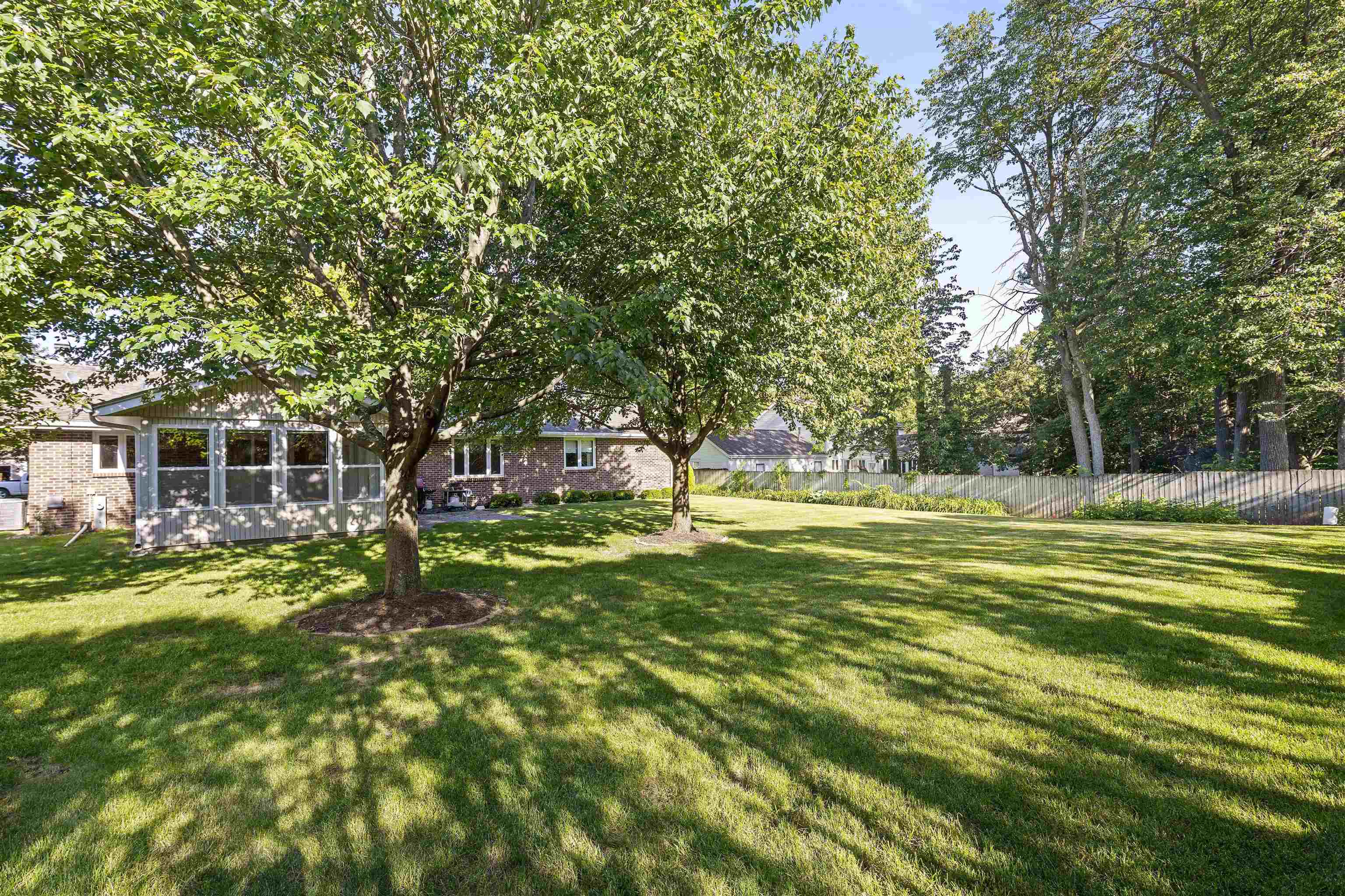 1732 Rowntree Lane Rockford, IL 61107 - Photo 25 of 26 a view of a house with a big yard and large trees