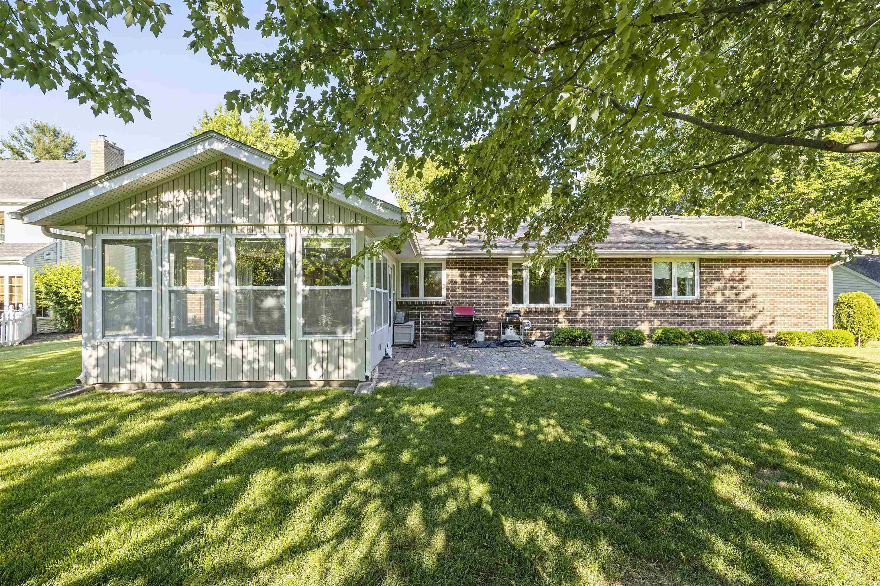 1732 Rowntree Lane Rockford, IL 61107 - Photo 26 of 26 a front view of a house with a garden and porch