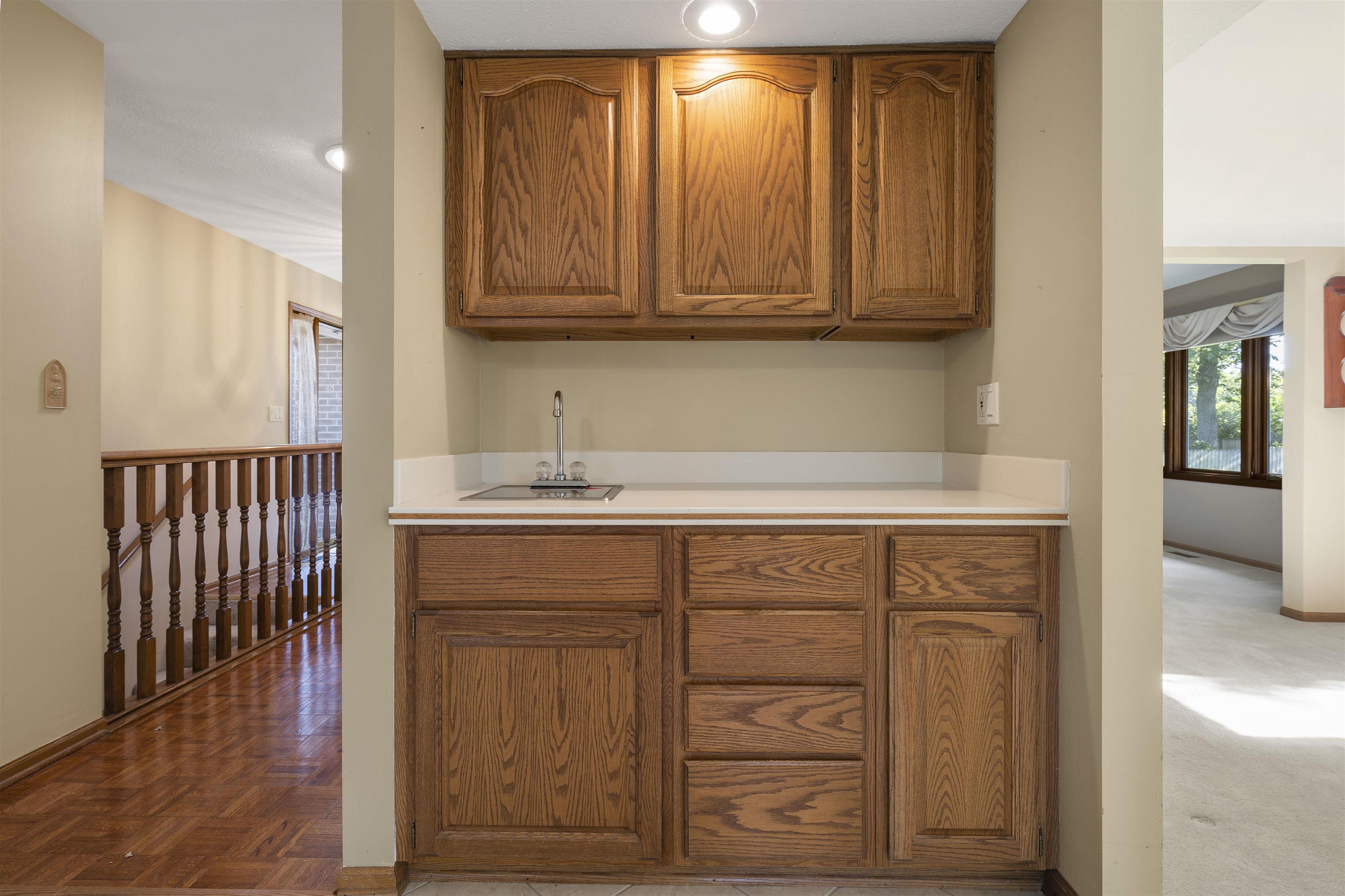 1732 Rowntree Lane Rockford, IL 61107 - Photo 5 of 26 a sink with wooden cabinets