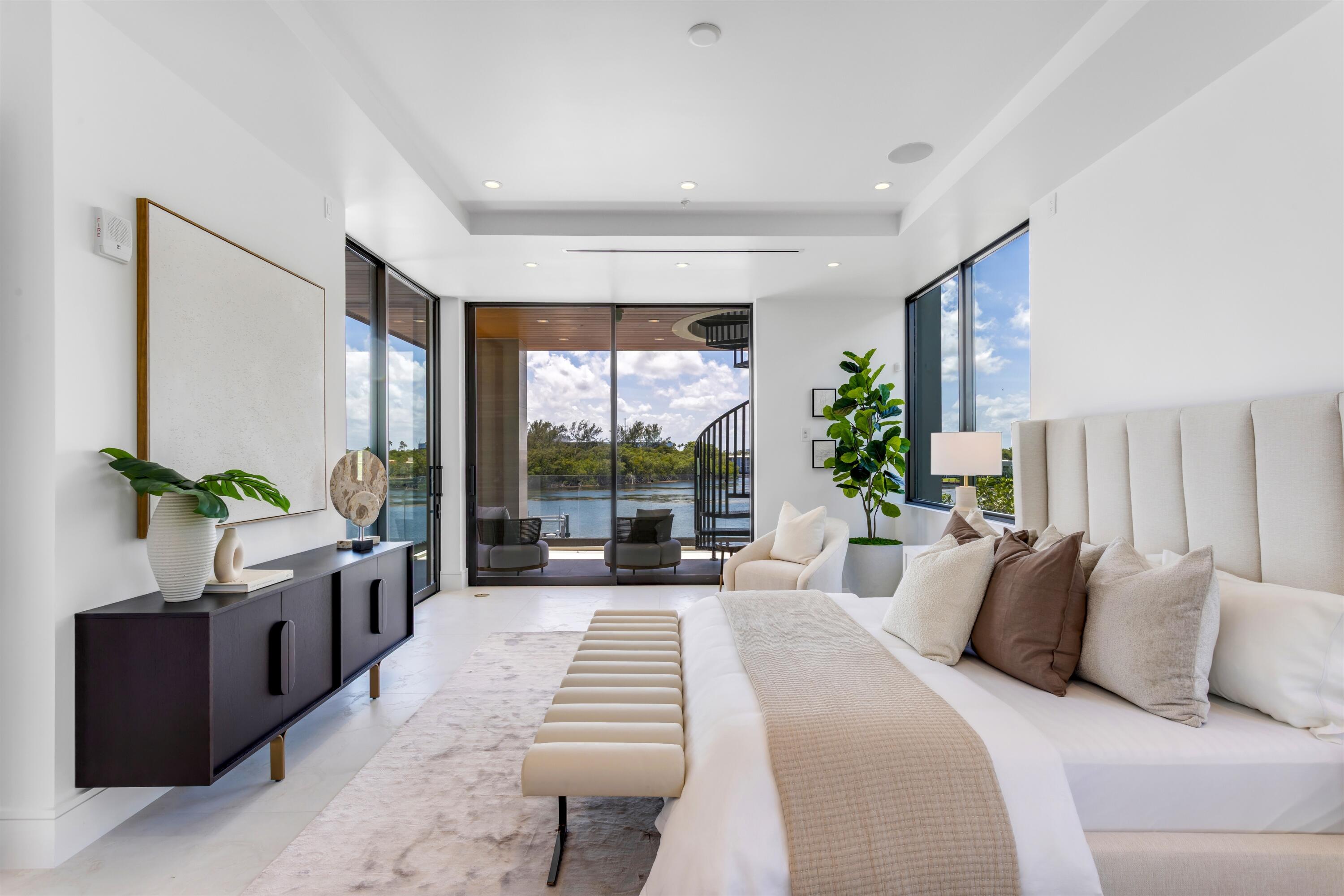 900 Lago Mar Lane, Unit PH Boca Raton, FL 33431 - Photo 21 of 58 a large bedroom with a large bed and a large window
