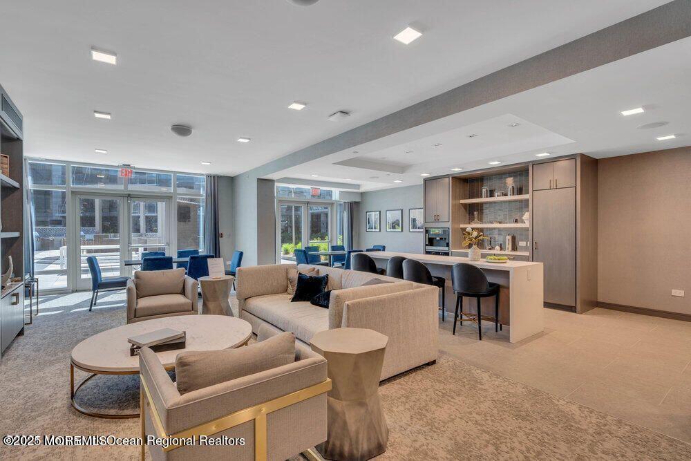 20 Melrose Terrace, Unit 509 Long Branch, NJ 07740 - Photo 21 of 24 a living room with couches a coffee table and kitchen view