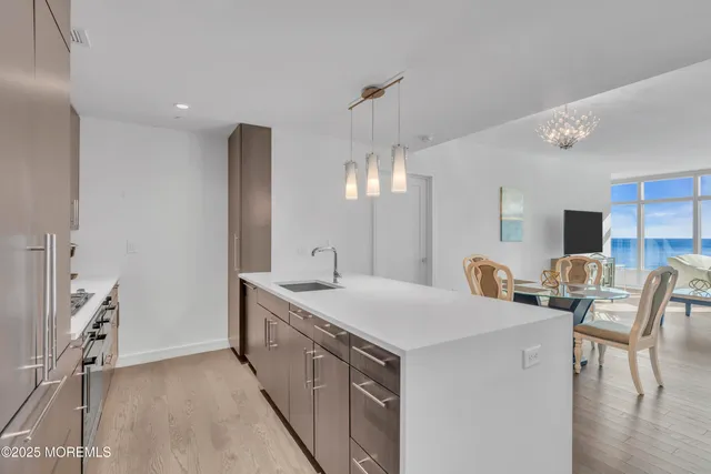 a view of a kitchen counter space a sink and a refrigerator