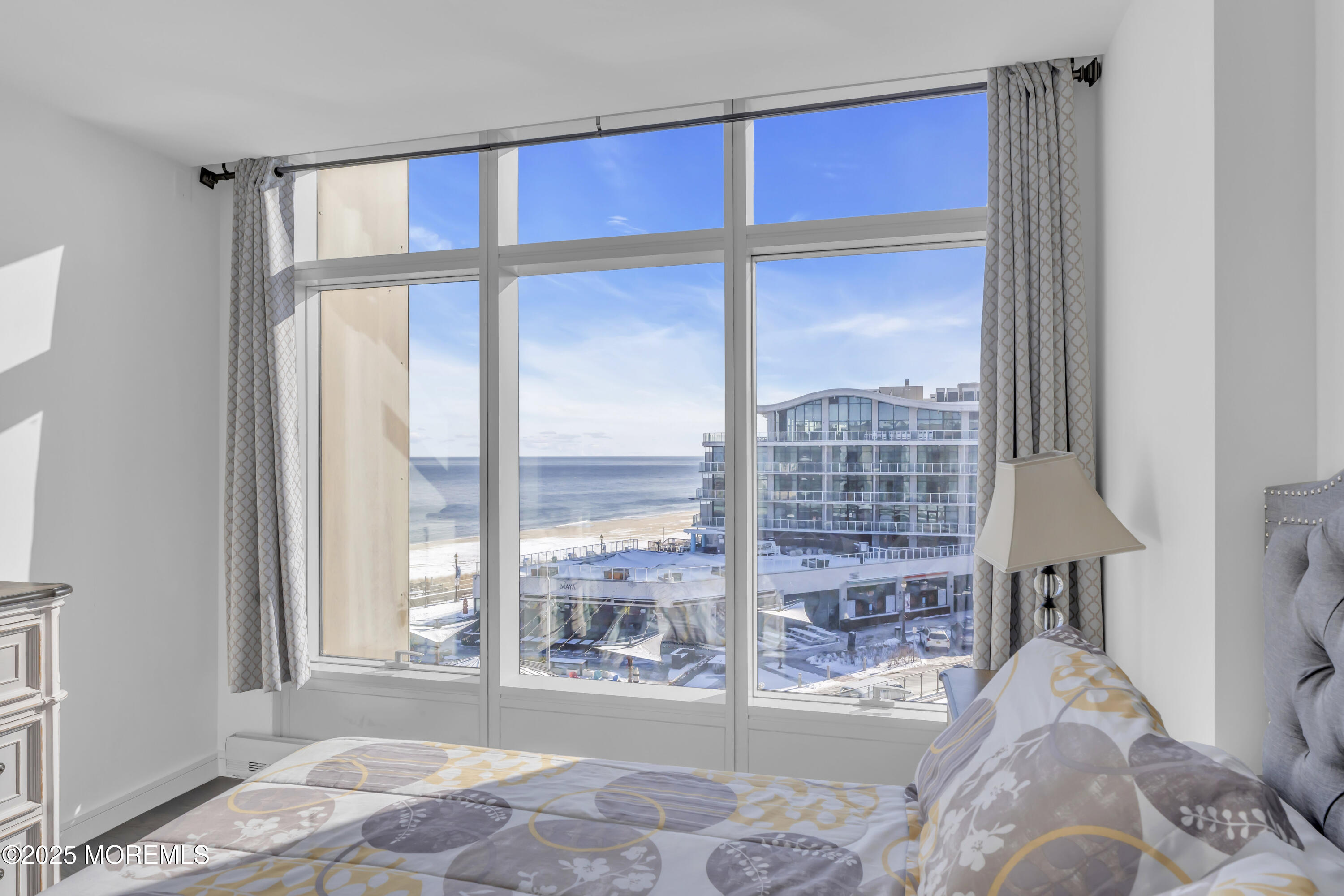 20 Melrose Terrace, Unit 509 Long Branch, NJ 07740 - Photo 10 of 24 a bedroom with a large window and a bed