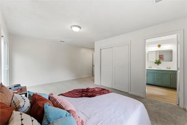 a bedroom with a bed and a mirror