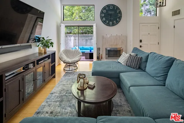 a living room with furniture a fireplace and a flat screen tv