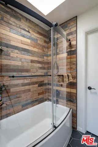 a bathroom with a bathtub and a shower