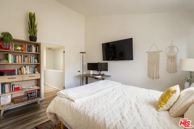a bedroom with a bed and a flat screen tv
