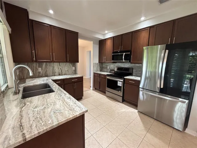 a kitchen with a sink and a large window