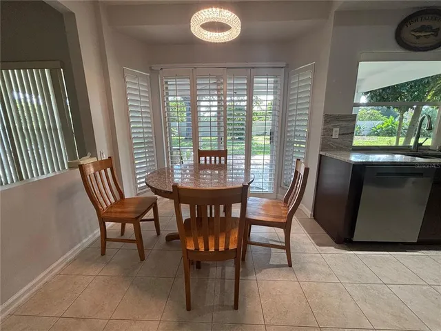 a dining room with furniture and a window