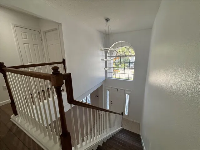 a living room with furniture wooden floor and a flat screen tv