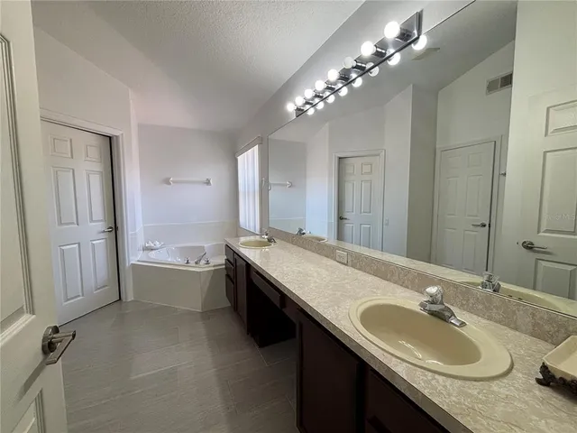 a white toilet sitting next to a white wall