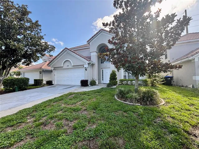 a front view of a house with a yard and garage