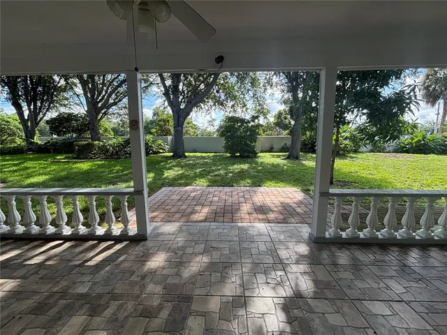 a view of a house with backyard and deck