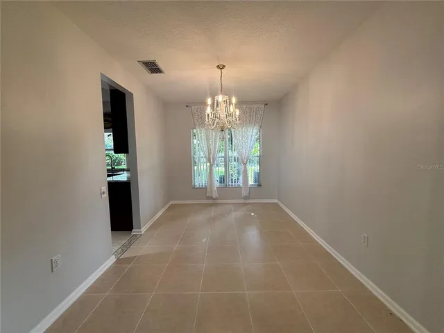 a kitchen with stainless steel appliances granite countertop a sink a stove and a wooden cabinets