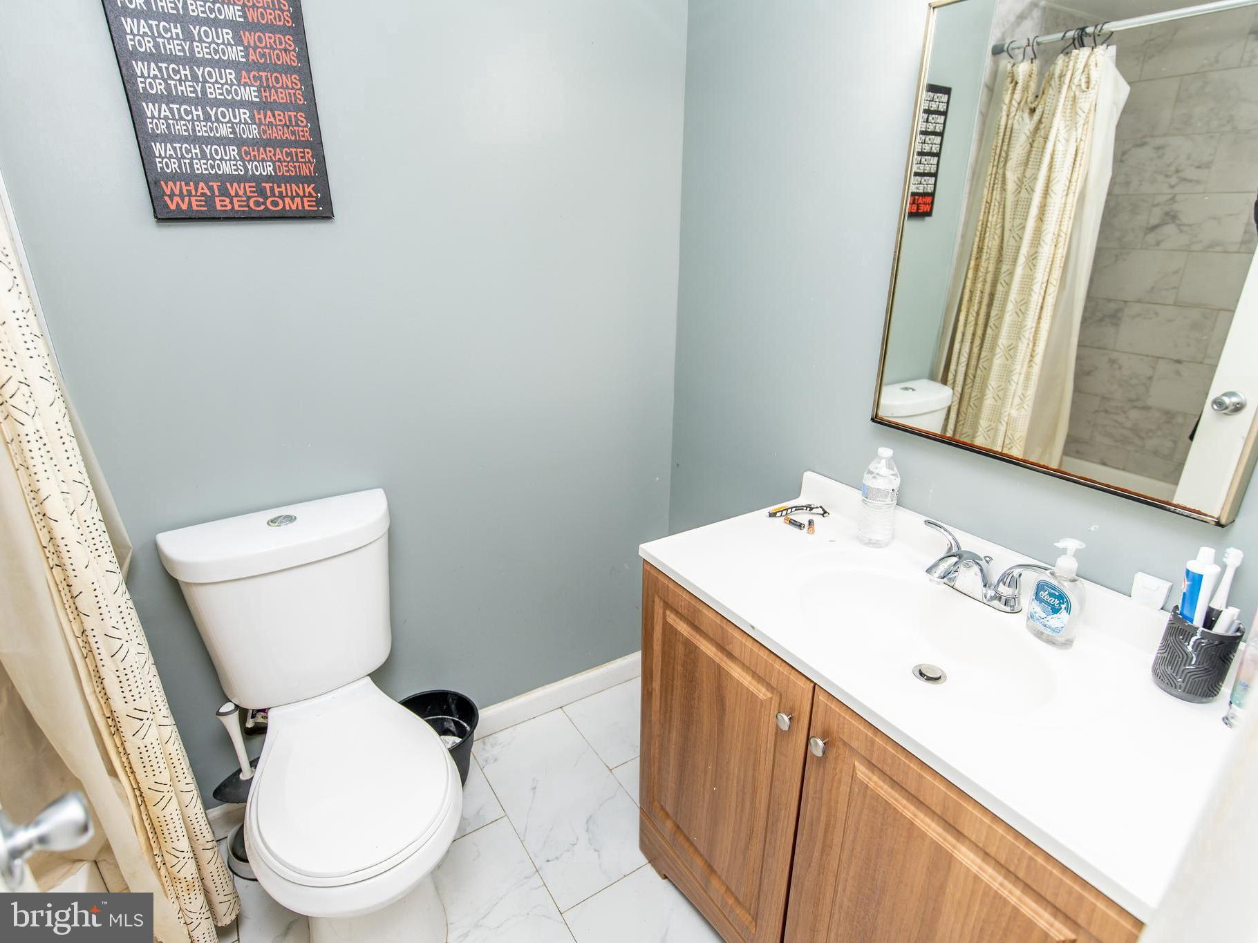 3934 Bel Pre Road, Unit 39342 Silver Spring, MD 20906 - Photo 20 of 30 a white toilet sitting next to a bathroom sink