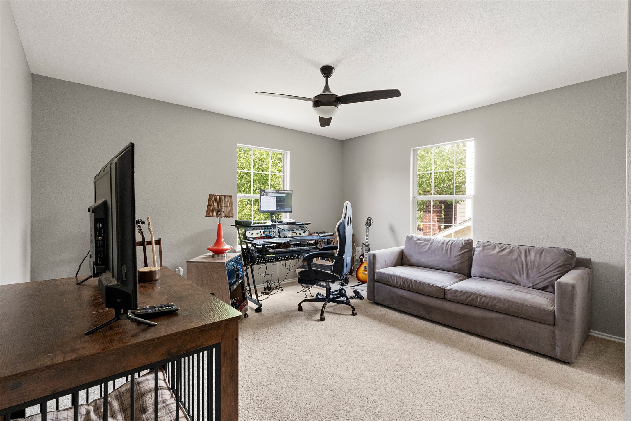 7009 Wandering Oak Road Austin, TX 78749 - Photo 27 of 36 Generous upstairs bedroom easily accommodates a full home office setup and couch, giving remote workers a quiet space to focus during the workday