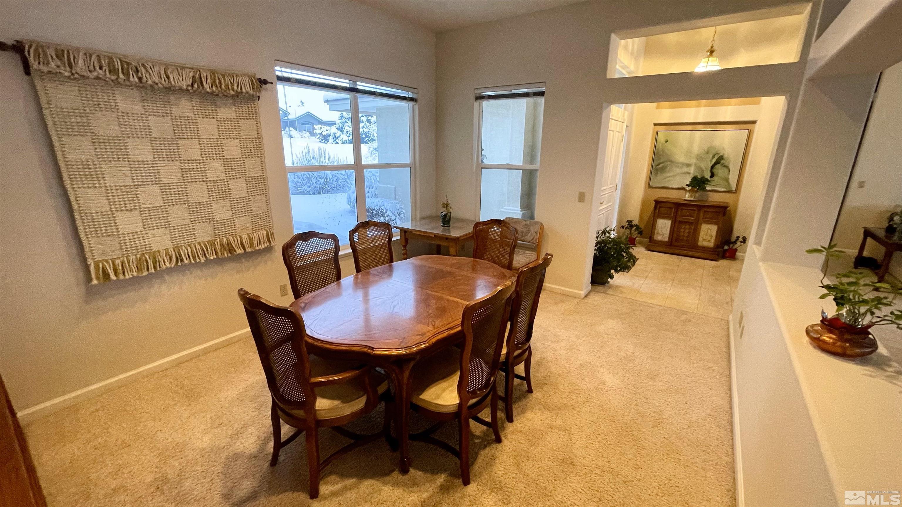 5120 West Acoma Road Reno, NV 89511 - Photo 25 of 39 a view of a dining room with furniture and a potted plant